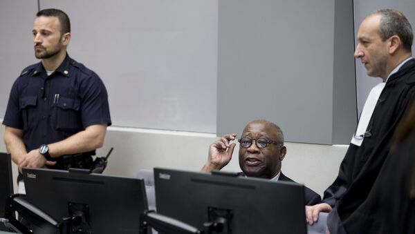 Former Ivory Coast president Laurent Gbagbo (C) and his lawyer Emmanuel Altit (R) wait for the start of his trial at the International Criminal Court in The Hague on January 28, 2016 - Sputnik International