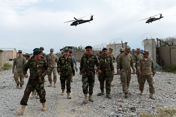 US army and Afghan National Army (ANA) soldiers walk as a NATO helicopter flies overhead US army and Afghan National Army (ANA) soldiers walk as a NATO helicopter flies overhead - Sputnik International