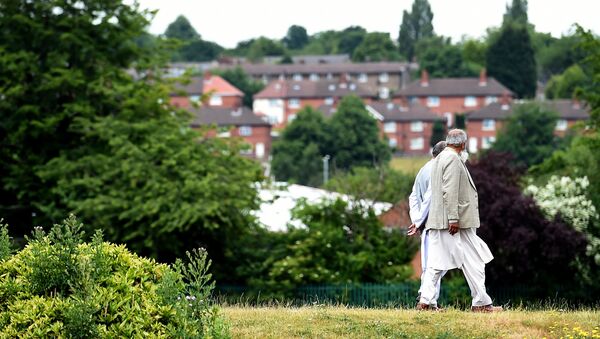 People walk in a park in Savile Town, Dewsbury - Sputnik International