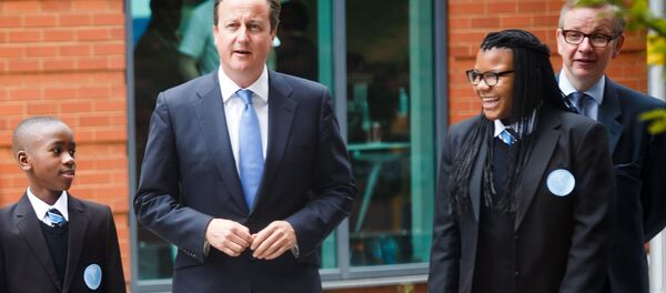Britain's Prime Minister David Cameron (2-L) and Secretary of State for Education Michael Gove (R) walk with students during the opening of the Perry Beeches III Free School in Birmingham on September 3, 2013 - Sputnik International
