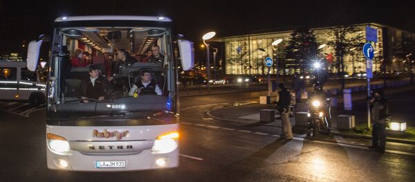 A bus carrying refugees with asylum status in Germany leaves the chancellery in Berlin on January 14, 2016, after it arrived from the Bavarian city of Landshut. . The bus carrying 31 refugees took them to a hotel where they will be able to spend the night before going to the destination of their choice A bus carrying refugees with asylum status in Germany leaves the chancellery in Berlin on January 14, 2016, after it arrived from the Bavarian city of Landshut. . The bus carrying 31 refugees took them to a hotel where they will be able to spend the night before going to the destination of their choice - Sputnik International