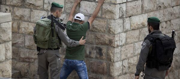 In this Friday, Oct. 23, 2015 file photo, an Israeli border police officer searches a Palestinian man at the Damascus Gate of Jerusalem's Old City ahead of Friday prayers In this Friday, Oct. 23, 2015 file photo, an Israeli border police officer searches a Palestinian man at the Damascus Gate of Jerusalem's Old City ahead of Friday prayers - Sputnik International