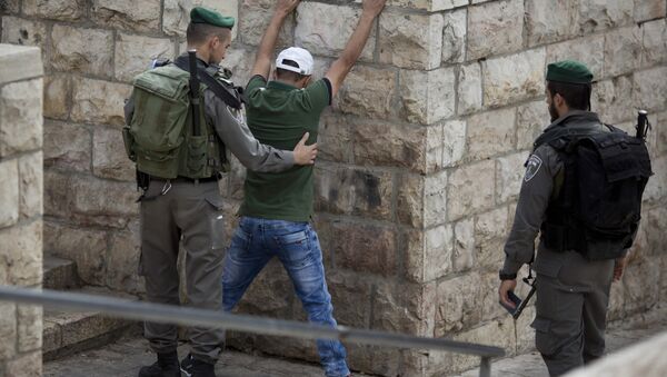 In this Friday, Oct. 23, 2015 file photo, an Israeli border police officer searches a Palestinian man at the Damascus Gate of Jerusalem's Old City ahead of Friday prayers - Sputnik International