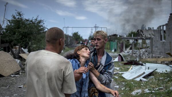 Local residents in the village of Luganskaya after the Ukrainian armed forces' air attack. File photo - Sputnik International
