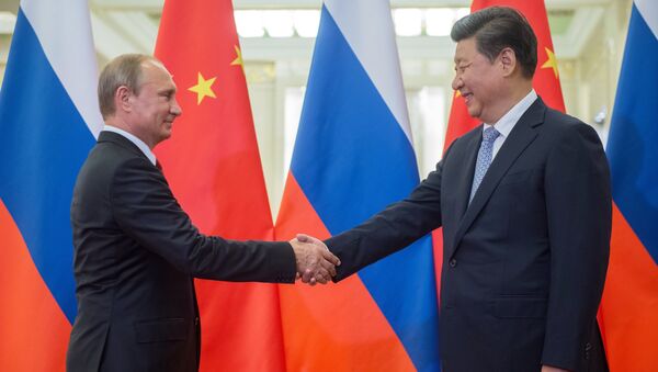 Russian President Vladimir Putin (left) and Chinese President Xi Jinping seen before the beginning of Russian-Chinese talks at the Great Hall of the People in Beijing, September 3, 2015 - Sputnik International