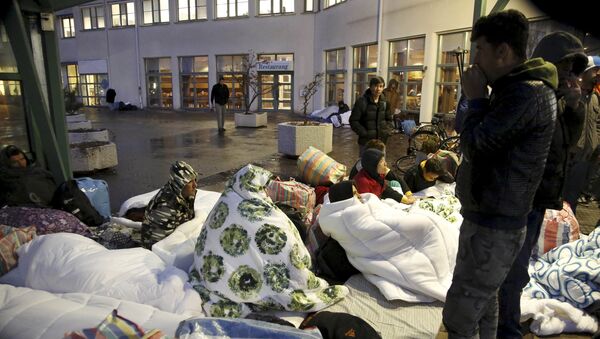 A file photo showing refugees sleeping outside the entrance of the Swedish Migration Agency's arrival center for asylum seekers at Jagersro in Malmo, Sweden, November 20, 2015. - Sputnik International