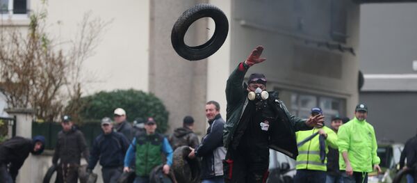 Protesting farmers throw tyres during clashes with riot policemen (not pictured) on February 2, 2016 in Saint-Lo, northwestern France - Sputnik International