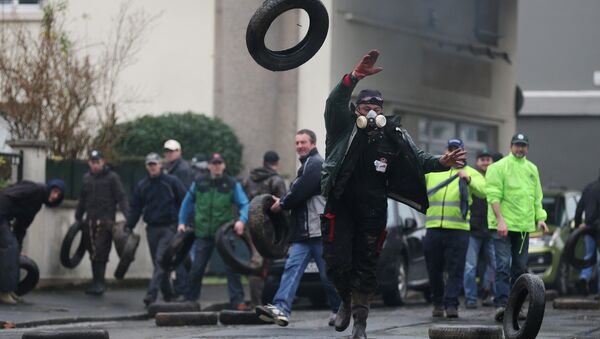 Protesting farmers throw tyres during clashes with riot policemen (not pictured) on February 2, 2016 in Saint-Lo, northwestern France - Sputnik International
