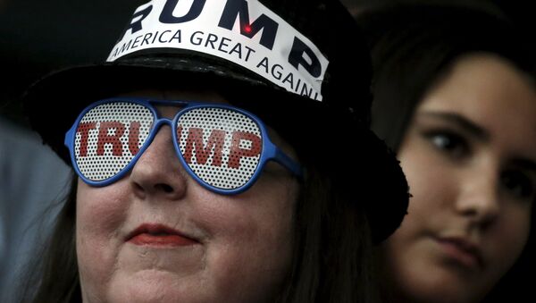 A supporter of Republican presidential candidate Donald Trump wears glasses with the word Trump on it as she listens to Mr Trump's remarks at a campaign rally in Milford, New Hampshire, February 2, 2016 - Sputnik International