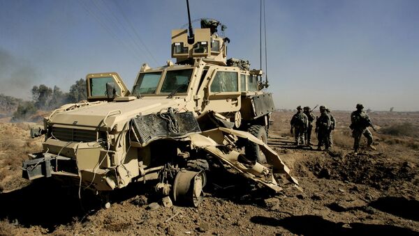  U.S. soldiers secure the area next to a damaged U.S. mine resistant, ambush protected vehicle (MRAP), after a roadside bomb explosion during an operation in the area of Al-leg, some 40 miles south of Baghdad, Iraq (File) - Sputnik International