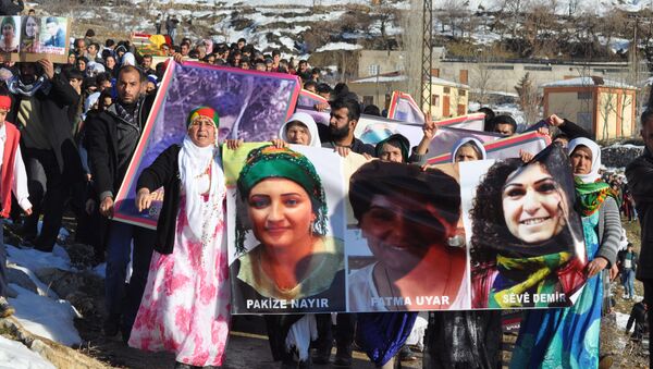 People hold pictures of victims from Cizre and Silopi killed during curfews during a funeral on January 12, 2016, in Sirnak - Sputnik International