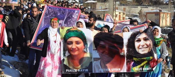 People hold pictures of victims from Cizre and Silopi killed during curfews during a funeral on January 12, 2016, in Sirnak People hold pictures of victims from Cizre and Silopi killed during curfews during a funeral on January 12, 2016, in Sirnak - Sputnik International