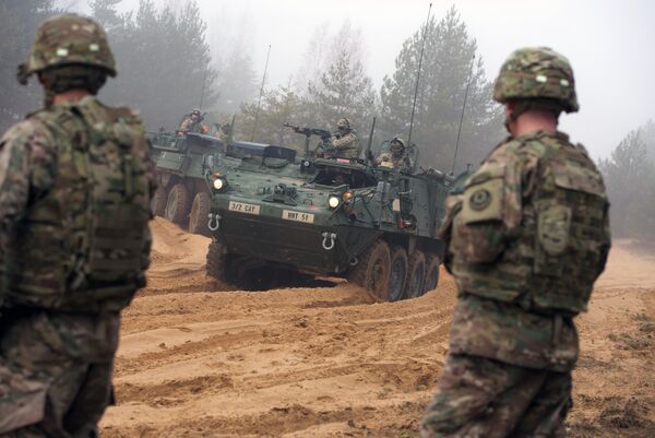 Picture taken on February 26, 2015 shows armored fighting vehicles IAV Stryker of the US Cavalry Regiment 2nd subdivision during training with Latvian an Canadian soldiers at the Adazi military training area in Latvia Picture taken on February 26, 2015 shows armored fighting vehicles IAV Stryker of the US Cavalry Regiment 2nd subdivision during training with Latvian an Canadian soldiers at the Adazi military training area in Latvia - Sputnik International