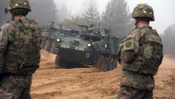 Picture taken on February 26, 2015 shows armored fighting vehicles IAV Stryker of the US Cavalry Regiment 2nd subdivision during training with Latvian an Canadian soldiers at the Adazi military training area in Latvia - Sputnik International