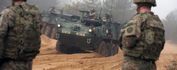 Picture taken on February 26, 2015 shows armored fighting vehicles IAV Stryker of the US Cavalry Regiment 2nd subdivision during training with Latvian an Canadian soldiers at the Adazi military training area in Latvia Picture taken on February 26, 2015 shows armored fighting vehicles IAV Stryker of the US Cavalry Regiment 2nd subdivision during training with Latvian an Canadian soldiers at the Adazi military training area in Latvia - Sputnik International