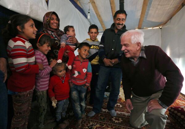 Canadian Minister of Immigration John McCallum, right, speaks with a Syrian family inside their tent, during his visit to a refugee camp in the southern town of Ghaziyeh, near the port city of Sidon, Lebanon, Friday, Dec. 18, 2015 Canadian Minister of Immigration John McCallum, right, speaks with a Syrian family inside their tent, during his visit to a refugee camp in the southern town of Ghaziyeh, near the port city of Sidon, Lebanon, Friday, Dec. 18, 2015 - Sputnik International
