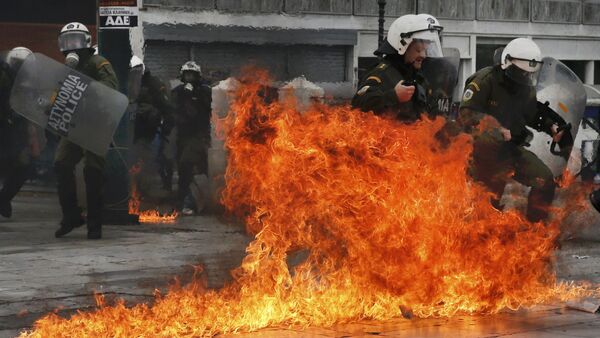 Riot police react to petrol bombs thrown by masked youths in Syntagma Square during a 24-hour general strike against planned pension reforms in Athens, Greece, February 4, 2016 - Sputnik International