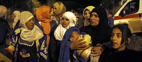 In this Monday, Jan. 11, 2016 photo, people wait to leave the besieged town of Madaya, northwest of Damascus, Syria. Aid convoys reached three besieged villages on Monday — Madaya, near Damascus, where about 400 people need to be evacuated immediately to receive life-saving treatment for medical conditions, malnourishment and starvation, and the Shiite villages of Foua and Kfarya in northern Syria In this Monday, Jan. 11, 2016 photo, people wait to leave the besieged town of Madaya, northwest of Damascus, Syria. Aid convoys reached three besieged villages on Monday — Madaya, near Damascus, where about 400 people need to be evacuated immediately to receive life-saving treatment for medical conditions, malnourishment and starvation, and the Shiite villages of Foua and Kfarya in northern Syria - Sputnik International