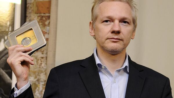 WikiLeaks founder Julian Assange holds up CD's containing data on offshore bank account holders, which he received from former Swiss private banker Rudolf Elmer at the Frontline club in London, Britain in this January 17, 2011 file photo - Sputnik International