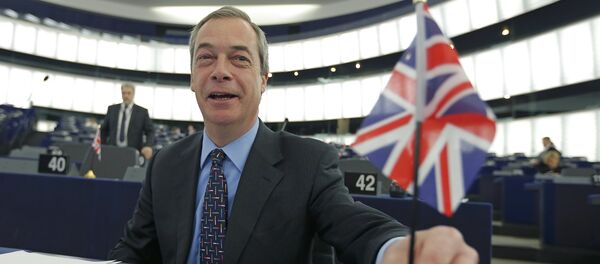 Nigel Farage, leader of the United Kingdom Independence Party (UKIP) and Member of the European Parliament, holds a British Union Jack flag as he arrives to take part in a debate on the upcoming summit and EU referendum in the UK, at the European Parliament in Strasbourg, France, February 3, 2016 - Sputnik International