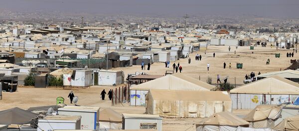 In this Wednesday, July 29, 2015 photo, Syrian refugees walk at Zaatari refugee camp, in Mafraq, Jordan In this Wednesday, July 29, 2015 photo, Syrian refugees walk at Zaatari refugee camp, in Mafraq, Jordan - Sputnik International