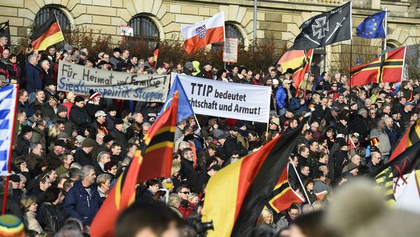 Supporters of the Pegida movement (Patriotic Europeans Against the Islamisation of the Occident) gather in Dresden, eastern Germany - Sputnik International