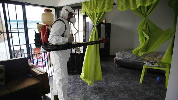 A health worker sprays insecticide inside the home of a woman diagnosed with the Zika virus in Acacias, Colombia - Sputnik International