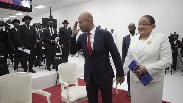 Haiti's former President Michel Martelly says goodbye as he accompanied by his wife Sophia at the end of a ceremony marking the end of his presidential term in the Haitian Parliament in Port-au-Prince, Haiti, February 7, 2016 - Sputnik International