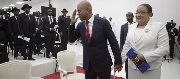 Haiti's former President Michel Martelly says goodbye as he accompanied by his wife Sophia at the end of a ceremony marking the end of his presidential term in the Haitian Parliament in Port-au-Prince, Haiti, February 7, 2016 - Sputnik International