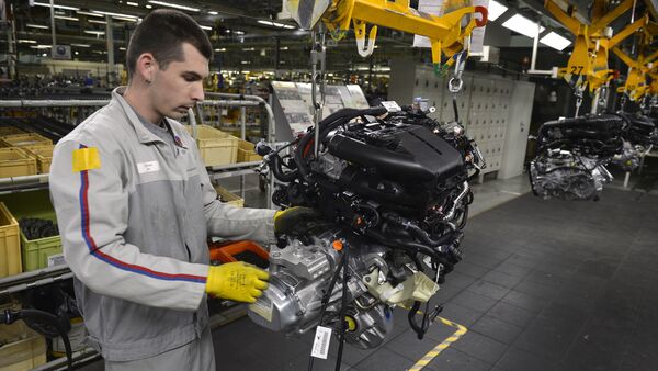 An employee works on the engine assembly line of the Peugeot 208 car by French car maker PSA Peugeot Citroen at the company's automobile factory in Trnava, western Slovakia - Sputnik International