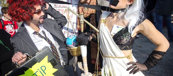 Dressed-up protesters take part in a rally against the Transatlantic Trade and Investment Partnership (TTIP), a massive free-trade accord being negotiated by the European Union and the United States, on October 10, 2015 in Amsterdam. - Sputnik International