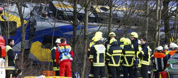 Members of emergency services stand next to a crashed train near Bad Aibling in southwestern Germany, February 9, 2016 Members of emergency services stand next to a crashed train near Bad Aibling in southwestern Germany, February 9, 2016 - Sputnik International
