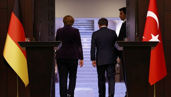 German Chancellor Angela Merkel (L) and Turkish Prime Minister Ahmet Davutoglu leave following a joint news conference in Ankara, Turkey February 8, 2016 - Sputnik International