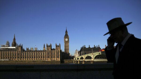 A man is silhouetted in front of the Houses of Parliament on a sunny winter's morning in London, Britain January 15, 2016. - Sputnik International