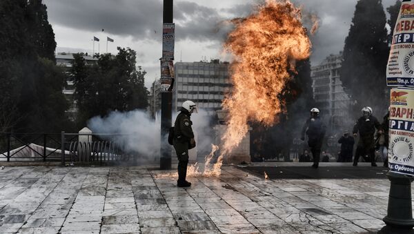 A firebomb explodes beside a riot police member during a massive protest in Athens on February 4, 2016. - Sputnik International