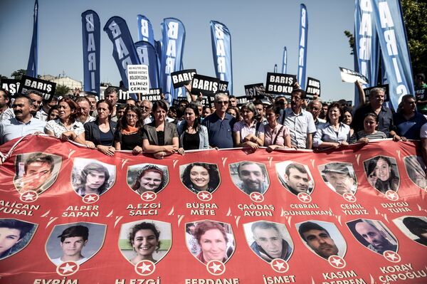 Protesters and members of Turkey's People's Democracy Party (HDP) hold a banner with pictures of the victims of the Suruc bomb attack after their peace march was banned by authorities in the Aksaray district of Istanbul on July 26. Protesters and members of Turkey's People's Democracy Party (HDP) hold a banner with pictures of the victims of the Suruc bomb attack after their peace march was banned by authorities in the Aksaray district of Istanbul on July 26. - Sputnik International