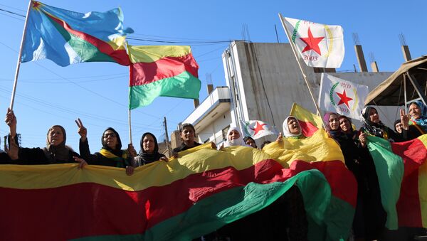 Kurdish women hold flags of the Kurdish People's Protection Units (YPG) political wing, the Democratic Union Party (PYD), and banners during a demonstration against the exclusion of Syrian-Kurds from the Geneva talks in the northeastern Syrian city of Qamishli on February 4, 2016 - Sputnik International