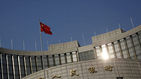 A Chinese national flag flies at the headquarters of the People's Bank of China, the country's central bank, in Beijing, China, January 19, 2016 - Sputnik International