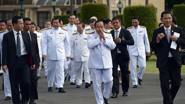Thailand's deputy prime minister and defence minister General Prawit Wongsuwan (C) makes a traditional greeting as he arrives for a cabinet group picture following a reshuffle on August 20 to include 10 new ministers, at Government House in Bangkok on August 25, 2015 - Sputnik International