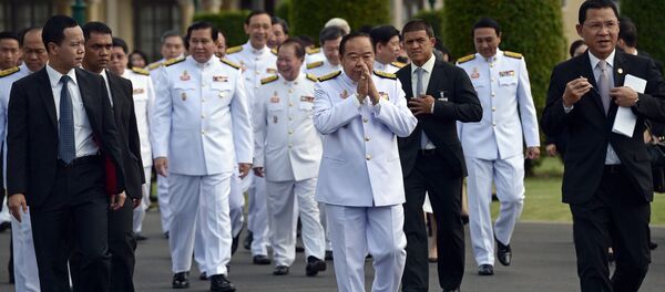 Thailand's deputy prime minister and defence minister General Prawit Wongsuwan (C) makes a traditional greeting as he arrives for a cabinet group picture following a reshuffle on August 20 to include 10 new ministers, at Government House in Bangkok on August 25, 2015 - Sputnik International