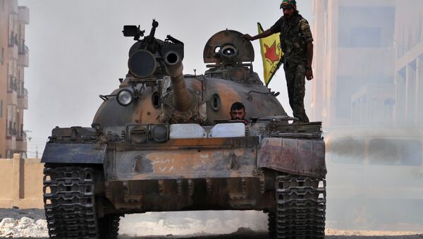 Fighters from the Kurdish People's Protection Units (YPG) drive a tank in the al-Zohour neighbourhood of northeastern Syrian city of Hasakeh (File) - Sputnik International