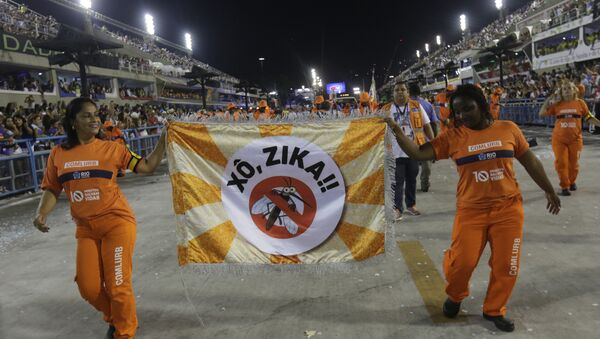 Workers holds a flag that reads in portugues Out Zika as part of a campaign to warn people about the spread of the Zika virus during carnival celebrations at the Sambadrome in Rio de Janeiro, Brazil, Monday, Feb. 8, 2016 - Sputnik International