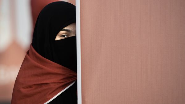A Bahraini woman takes part in an anti-government protest that marks a 1000 days since the Shiite-led uprising demanding democratic reforms in Sunni-ruled but Shiite-majority Bahrain, in the village of al-Shakhurah, west of Manama, on December 13, 2013. - Sputnik International