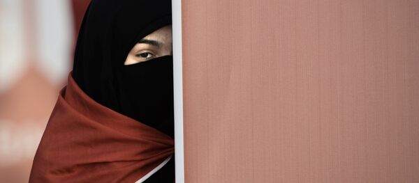 A Bahraini woman takes part in an anti-government protest that marks a 1000 days since the Shiite-led uprising demanding democratic reforms in Sunni-ruled but Shiite-majority Bahrain, in the village of al-Shakhurah, west of Manama, on December 13, 2013. A Bahraini woman takes part in an anti-government protest that marks a 1000 days since the Shiite-led uprising demanding democratic reforms in Sunni-ruled but Shiite-majority Bahrain, in the village of al-Shakhurah, west of Manama, on December 13, 2013. - Sputnik International