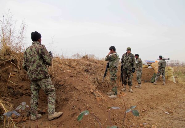 Afghan National Army (ANA) soldiers stand guard during an operation against Taliban militants in the Nad Ali district of Helmand on December 26, 2015 Afghan National Army (ANA) soldiers stand guard during an operation against Taliban militants in the Nad Ali district of Helmand on December 26, 2015 - Sputnik International