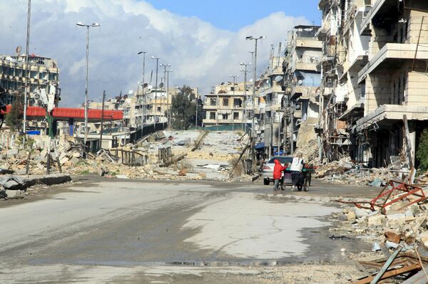 Residents push a cart near al-Shaar bridge in Aleppo's al-Shaar neighborhood, Syria. file photo Residents push a cart near al-Shaar bridge in Aleppo's al-Shaar neighborhood, Syria. file photo - Sputnik International