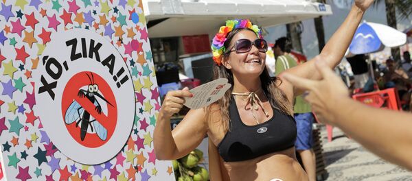 Viviane Oliveira, who's three months pregnant, dances next to a sign that reads in Portuguese : Get out Zika during a street carnival on Ipanema beach in Rio de Janeiro, Brazil, Sunday, Jan. 31, 2016 Viviane Oliveira, who's three months pregnant, dances next to a sign that reads in Portuguese : Get out Zika during a street carnival on Ipanema beach in Rio de Janeiro, Brazil, Sunday, Jan. 31, 2016 - Sputnik International