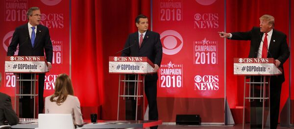 Republican U.S. presidential candidates former Governor Jeb Bush (L) and businessman Donald Trump (R) speak simultaneously about the war in Iraq and the record of Bush's brother, former President George W. Bush, as Senator Ted Cruz (C) looks on during the Republican U.S. presidential candidates debate sponsored by CBS News and the Republican National Committee in Greenville, South Carolina February 13, 2016. - Sputnik International