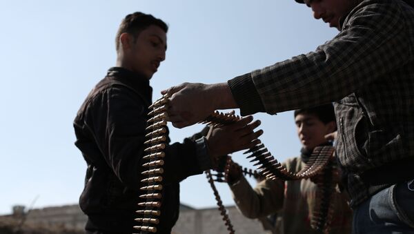 Opposition fighters belonging to Jaish al-Islam (Islam Army), the foremost rebel group in Damascus province who fiercely oppose to both the regime and the Islamic State group, check their ammunition belts in Tal al-Aswan in the area of the eastern Ghouta rebel bastion east of the Syrian capital, Damascus, during clashes with government forces on February 9, 2016. - Sputnik International