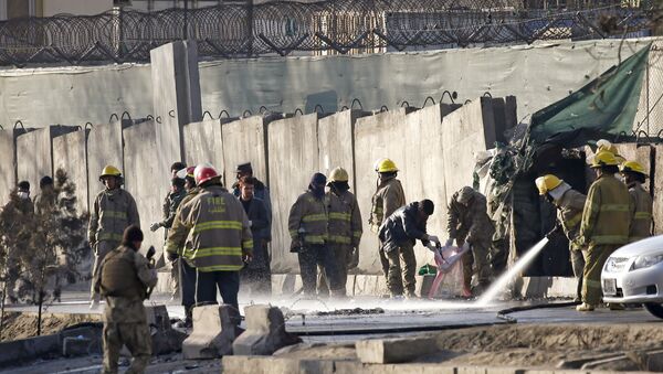 Afghan fire-fighters and members of security forces clean the site of a suicide attack in Kabul, Afghanistan. - Sputnik International